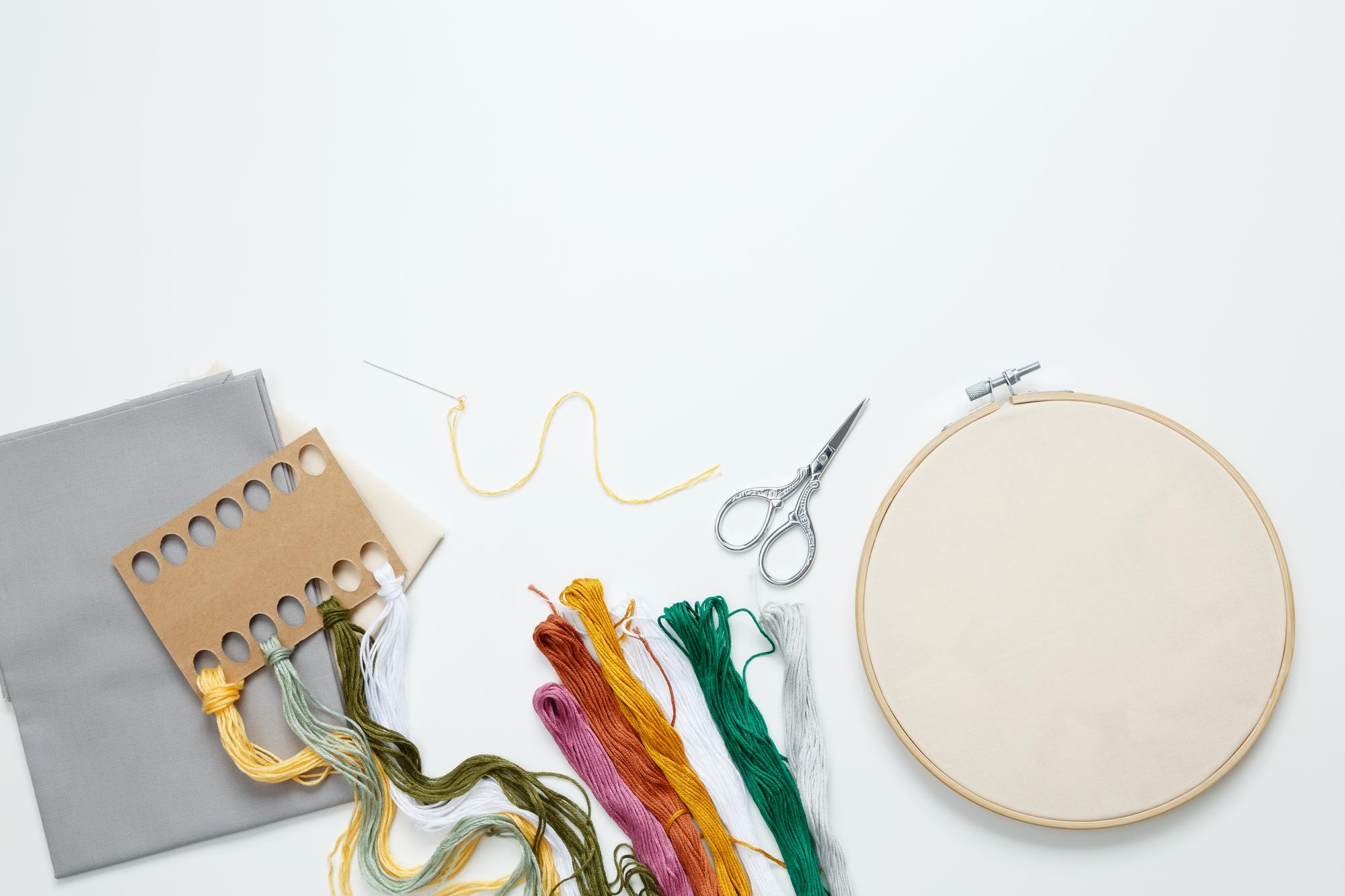 atelier workspace with embroidery tools and samples