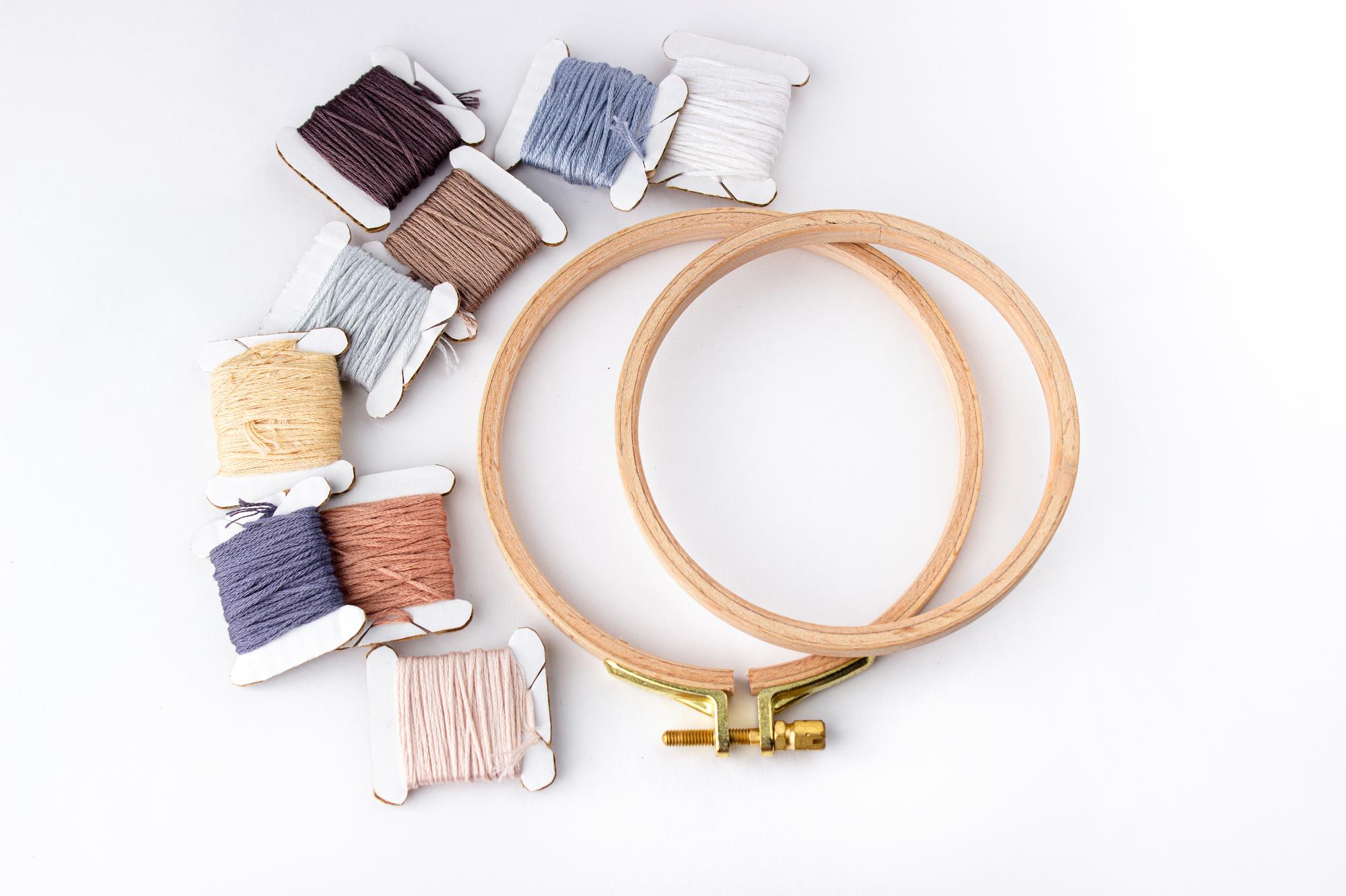 selection of embroidered patches and thread spools